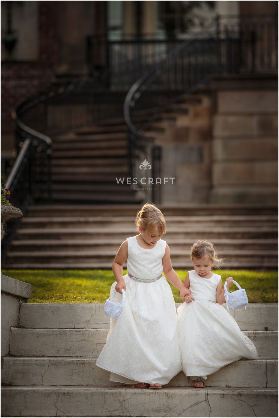 The flower girls at Kim & Dan's wedding carefully descend the east lawn staircase at Cantigny Park & Gardens in Wheaton, IL.